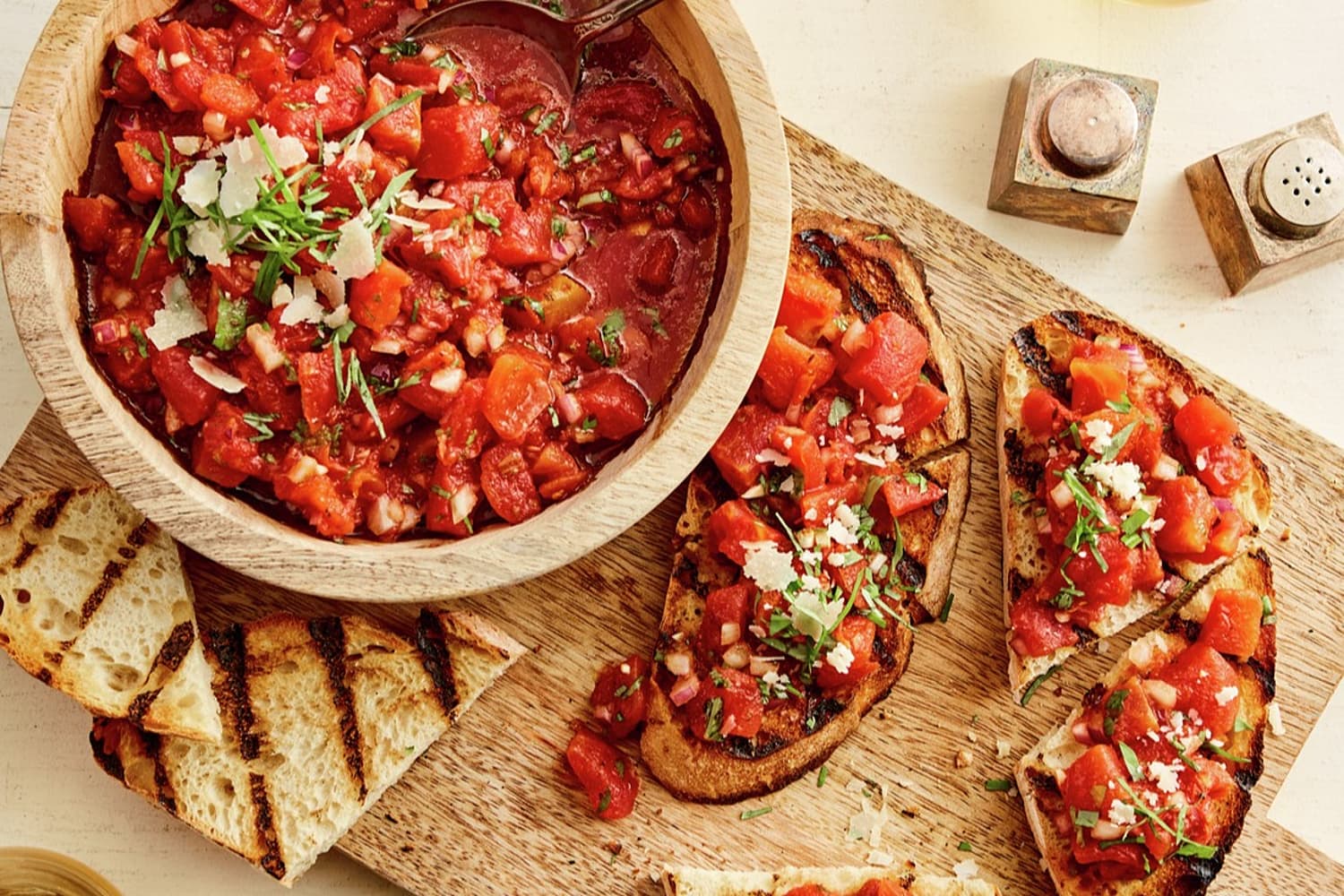Roasted tomatoes on top of bread and in a bowl 